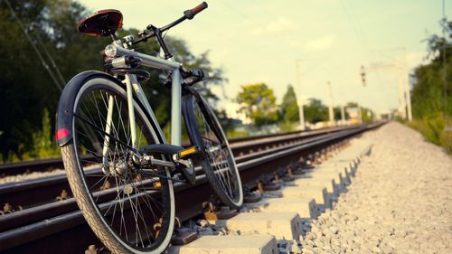 Bicycle parked by railroad track