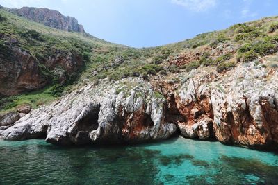 Scenic view of sea and mountains against sky