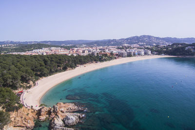 High angle view of city by sea against sky