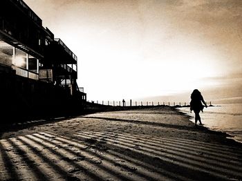 Reflection of people in water at sunset