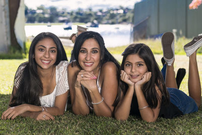 Portrait of smiling family lying on grass