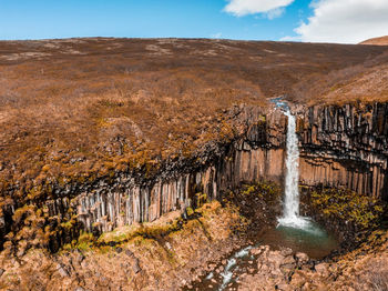 Aerial view of the svartifoss waterfall surrounded by basalt columns