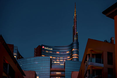 Low angle view of buildings against sky at night