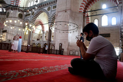 Side view of woman photographing