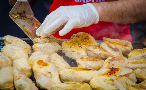 Midsection of man preparing food at market stall