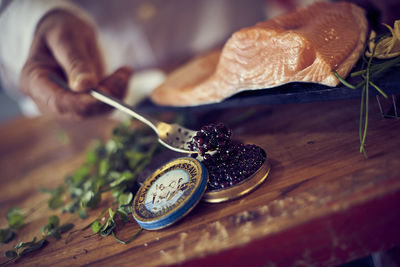 Close-up of hand holding caviar