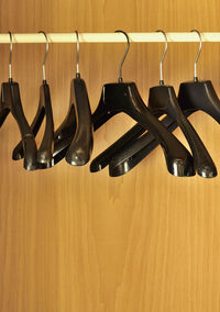 Close-up of coathangers hanging in cabinet