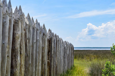 Panoramic shot of wooden post on land against sky