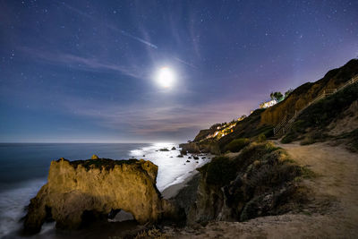 Scenic view of sea against star field