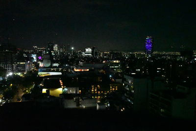 High angle view of illuminated buildings in city at night