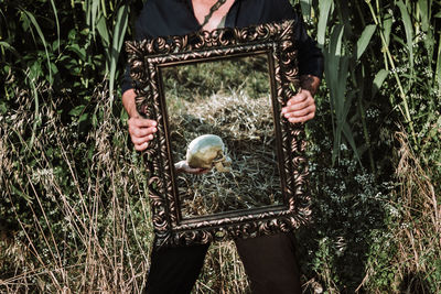 Person holding bird on land