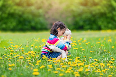 Cute girl with cat on field