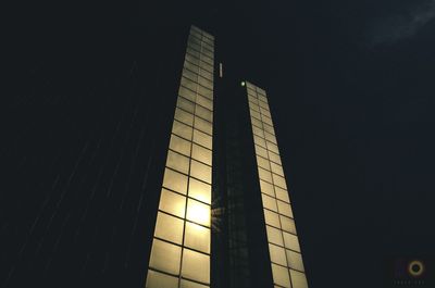 Low angle view of modern building against sky at night