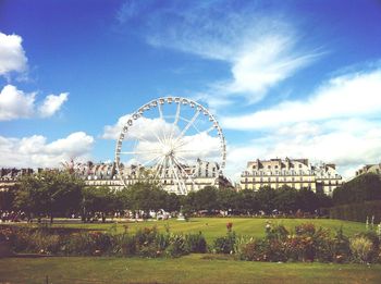 Ferris wheel against cloudy sky