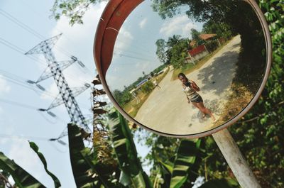 Reflection of woman standing on road