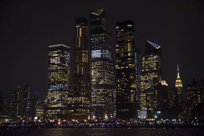 Illuminated buildings against sky at night