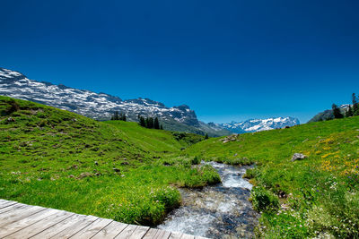 Scenic view of mountains against clear blue sky