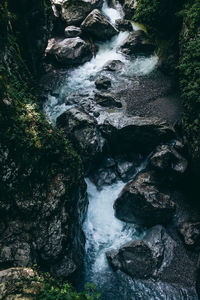 Stream flowing through rocks in forest