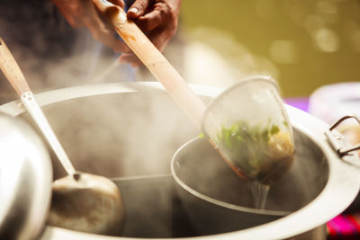 Close-up of person preparing food in kitchen