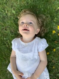 Portrait of cute baby girl on field