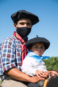 Argentinian father and son with face mask