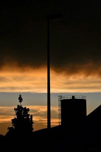 Low angle view of silhouette built structure against sky at sunset