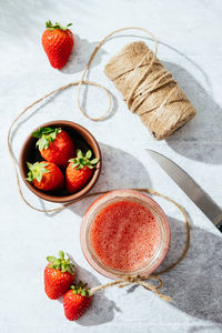 High angle view of strawberries in bowl on table