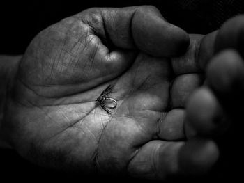 Close-up of cropped hand holding text