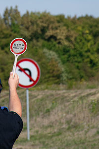 Policeman holding stop sign 