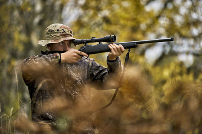 Teenage boy with rifle at hunting