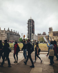 People on city buildings against sky