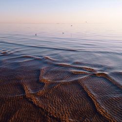 Scenic view of sea against sky at sunset