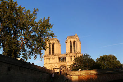 Low angle view of historic building against clear blue sky