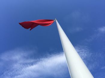 Low angle view of danger flag against sky