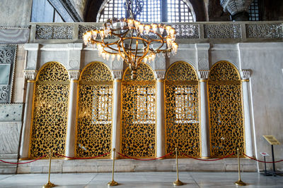 Low angle view of ornate hanging outside building