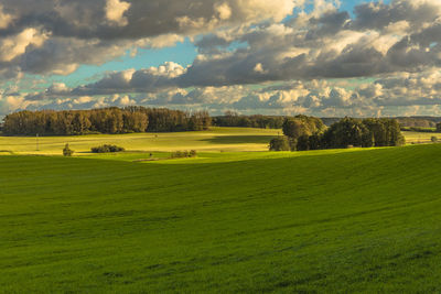 Scenic view of golf course against sky