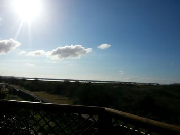 Scenic view of landscape against sky on sunny day