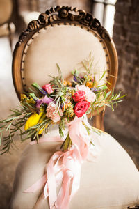 Close up of a bright wedding bouquet standing on the chair