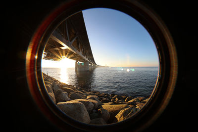 Sun seen through the oresund bridge at the viewpoint near limhamn sweden. wide angle, clear sky