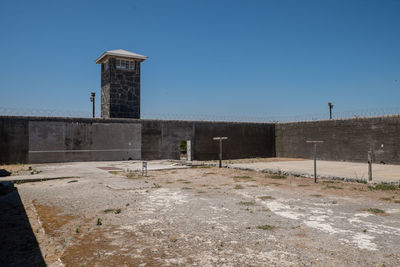 Tower on field against clear sky