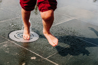 Low section of man running on footpath