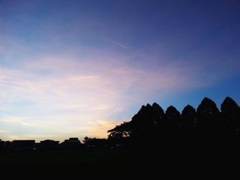 Silhouette trees against sky during sunset