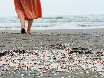 Low section of person standing on beach