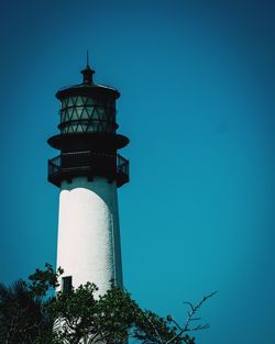 Low angle view of lighthouse against clear blue sky