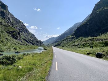 Road amidst mountains against sky