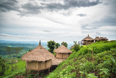 House amidst trees and buildings against sky