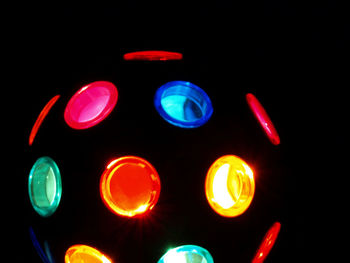 Close-up of illuminated lights against black background