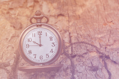 High angle view of clock on weathered wood