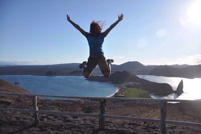 Woman jumping in air on beach