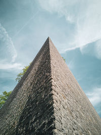 Low angle view of historical building against cloudy sky